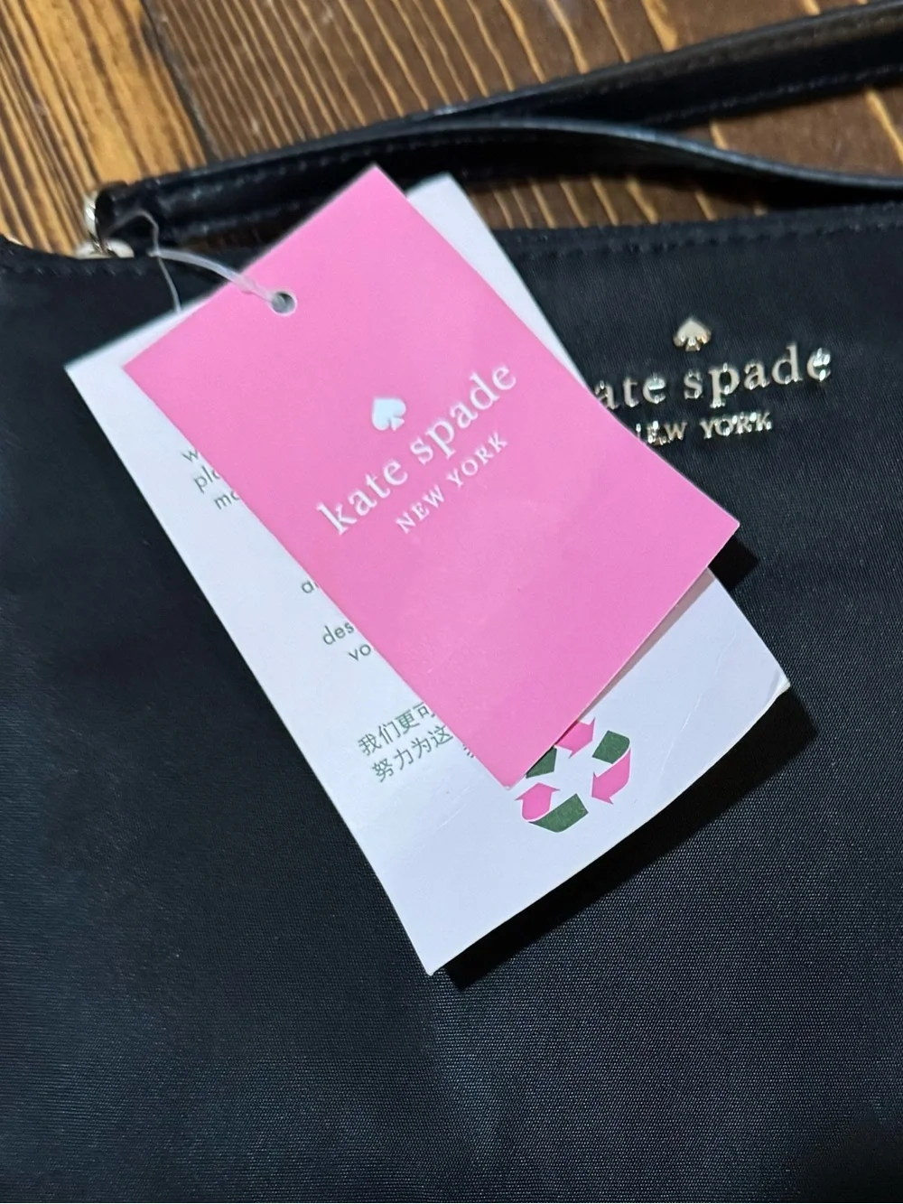 kate spade “Chelsea the Little” black wristlet clutch with gold logo